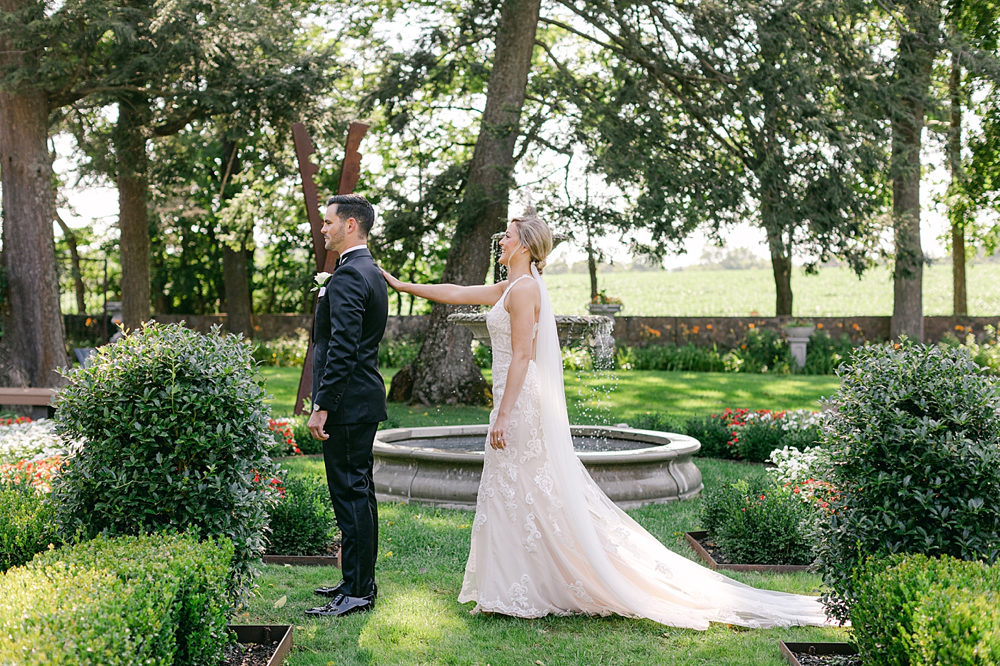 Bride and groom first look in a garden | Image by Hope Helmuth Photography