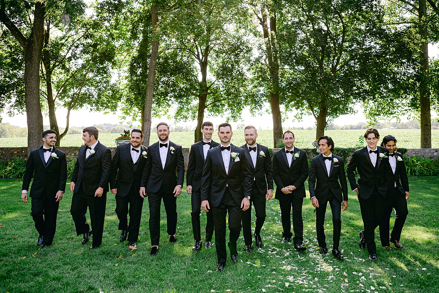 Groomsmen walking through a garden | Image by Hope Helmuth Photography