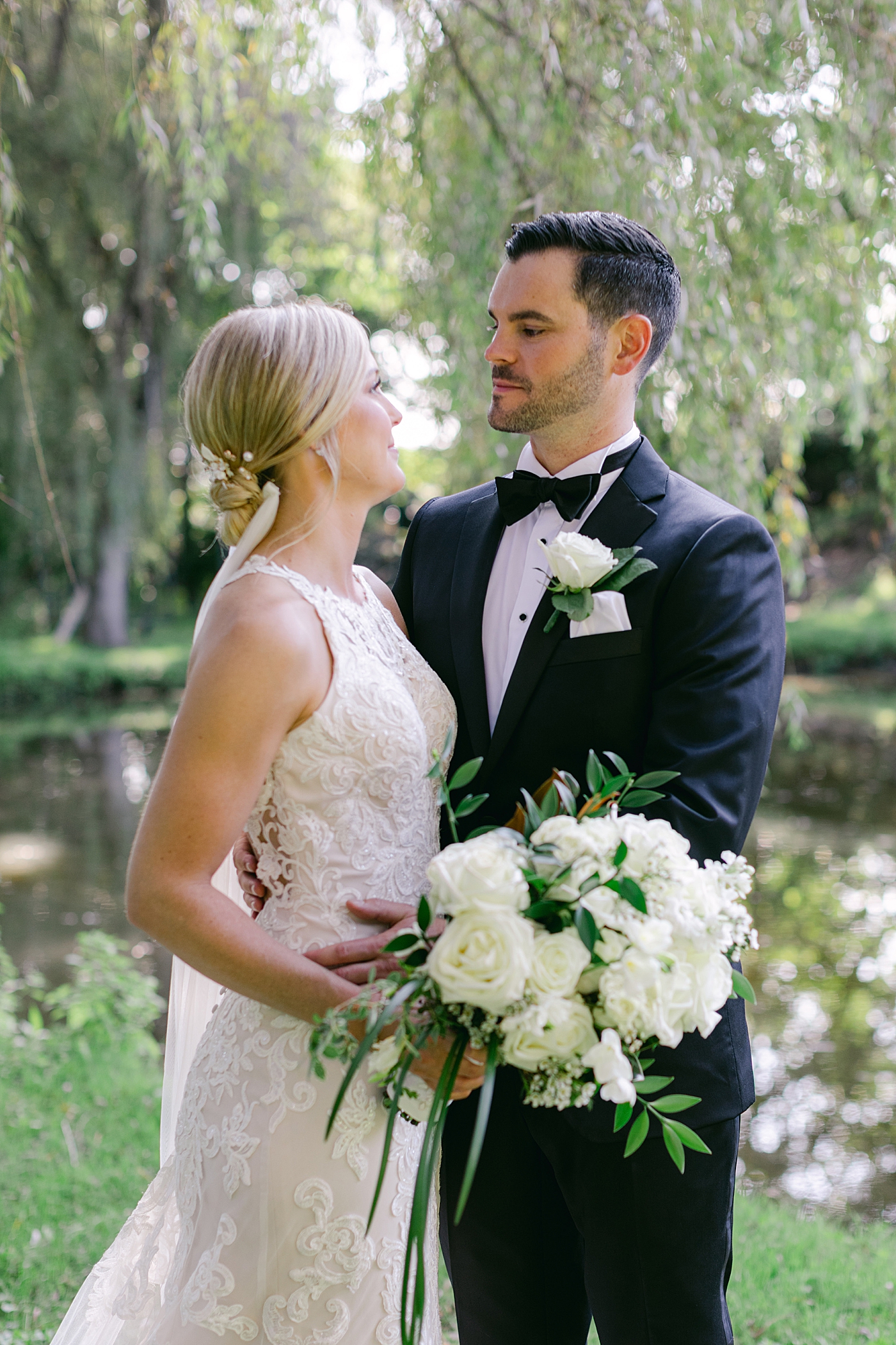 Bride and groom near a pond | Image by Hope Helmuth Photography
