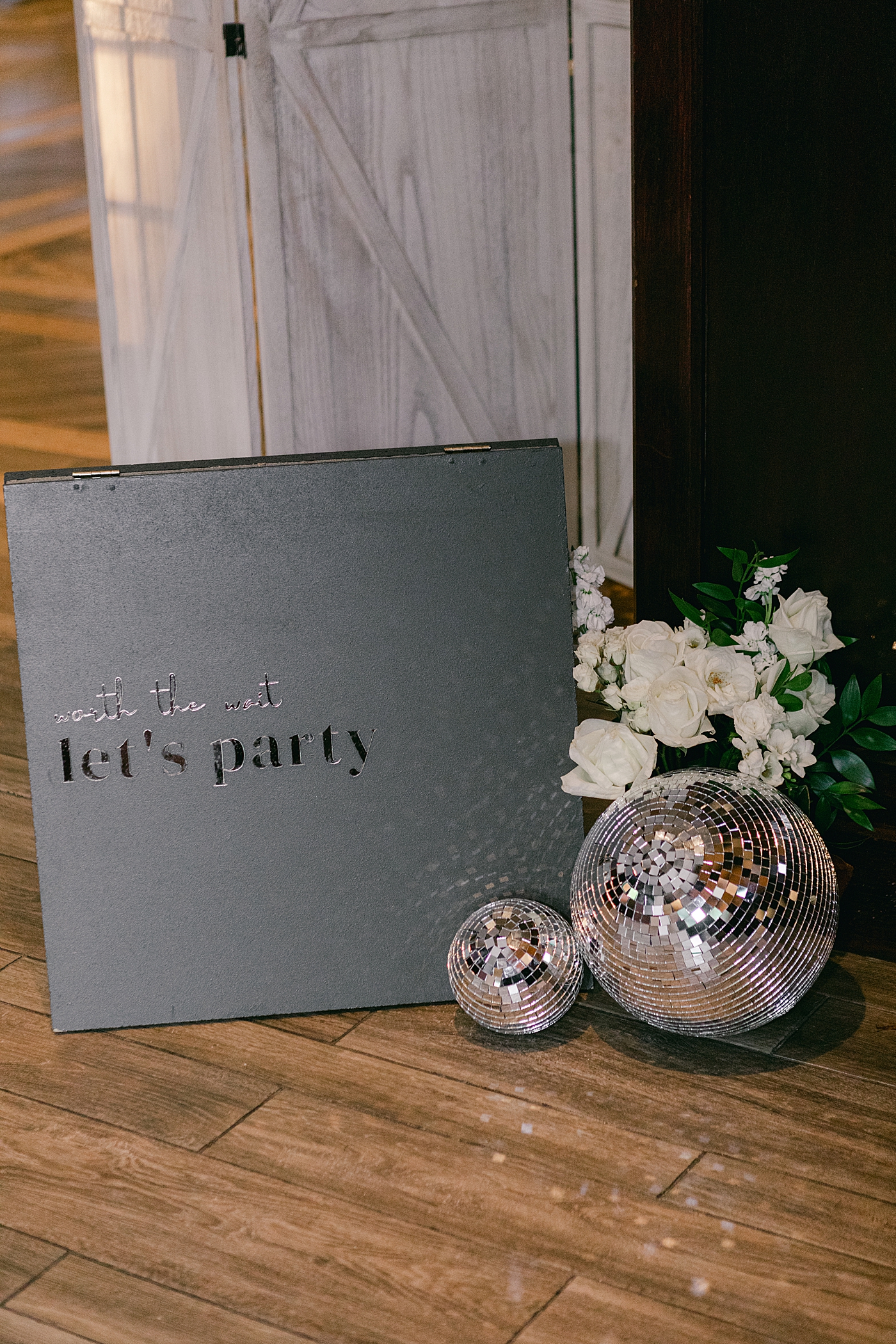 Wedding sign with disco balls | Image by Hope Helmuth Photography
