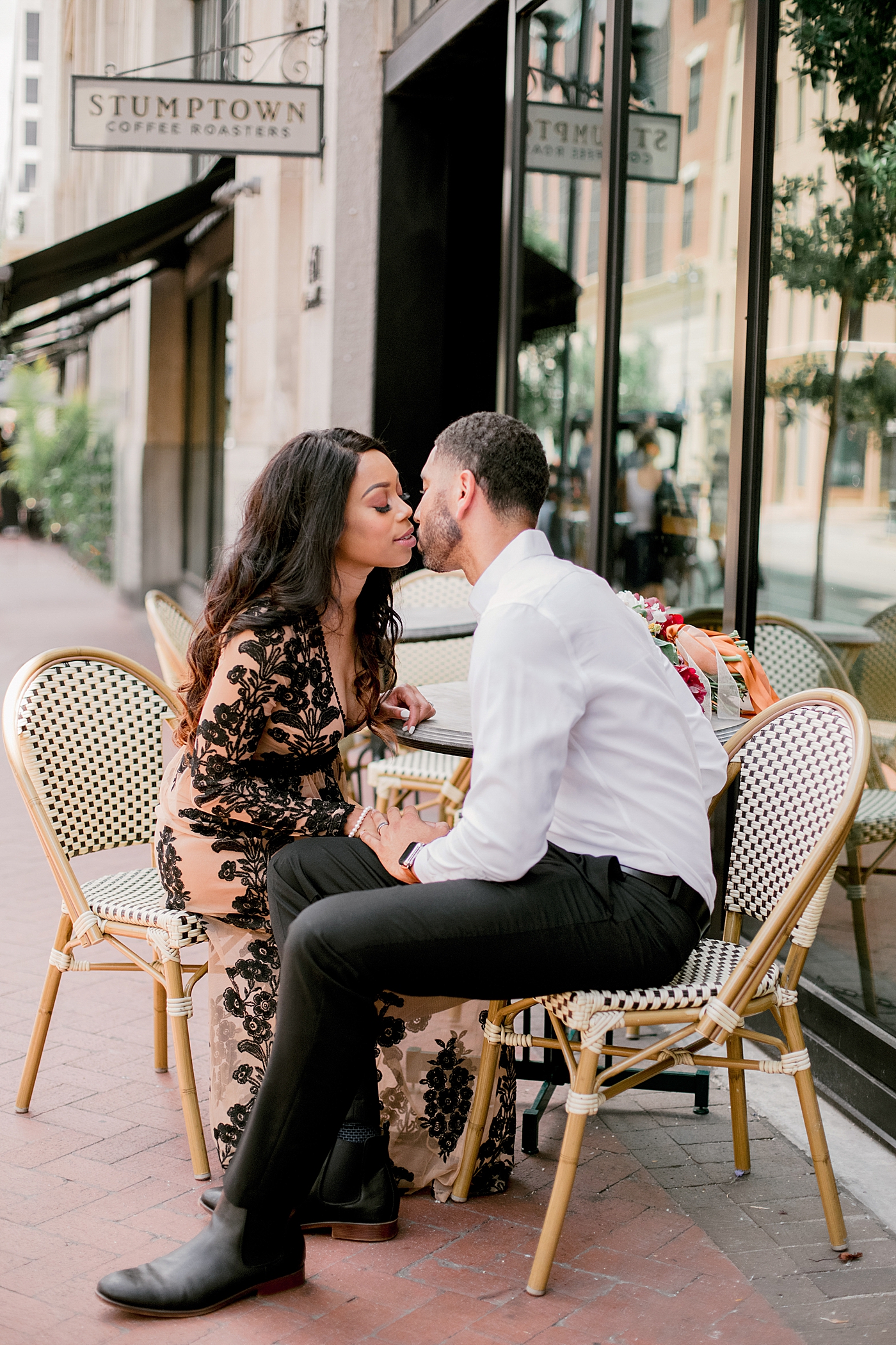 Couple sitting at a bistro table in new orleans | Photo by Hope Helmuth Photography