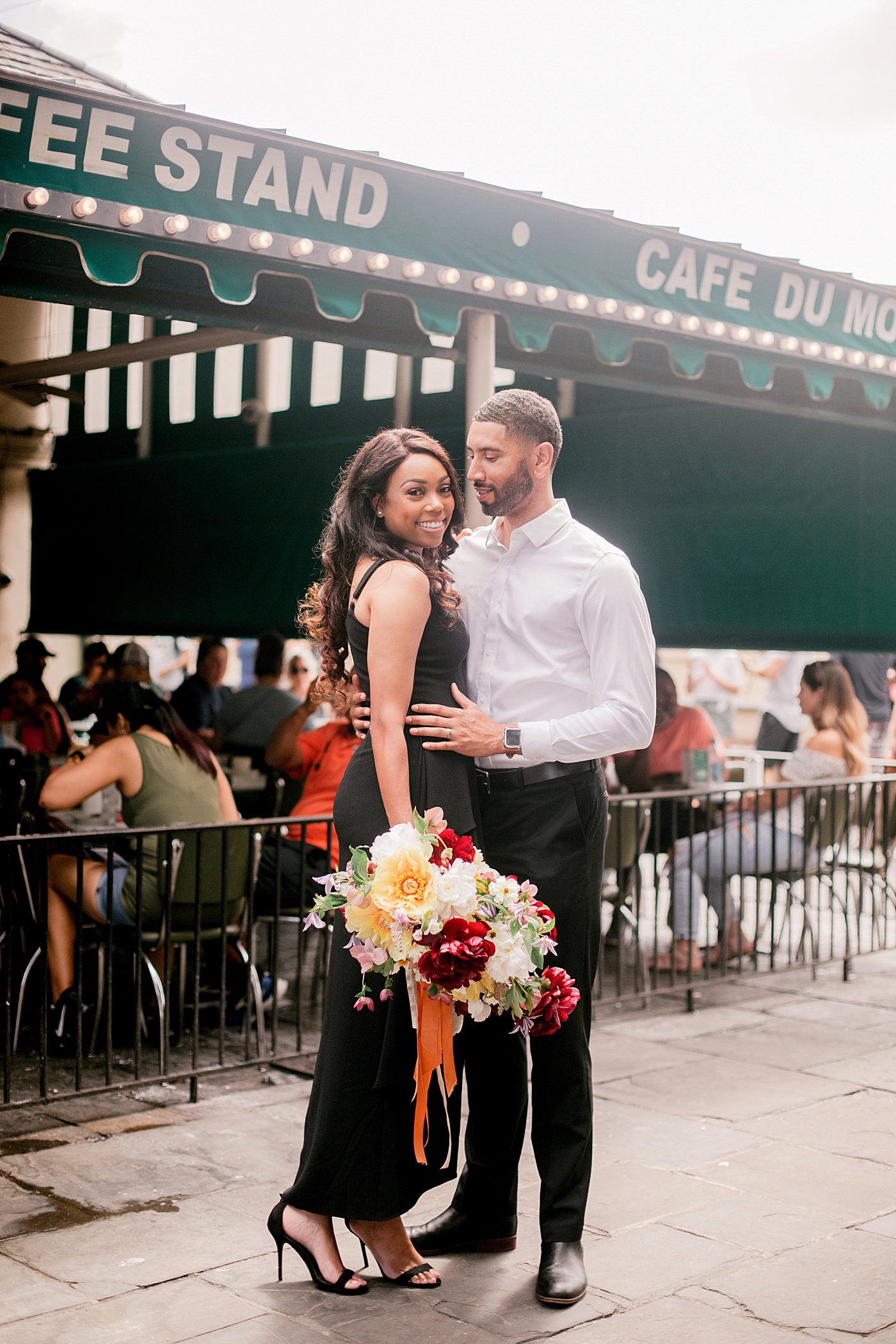 Couple posing together with a bouquet | Photo by Hope Helmuth Photography