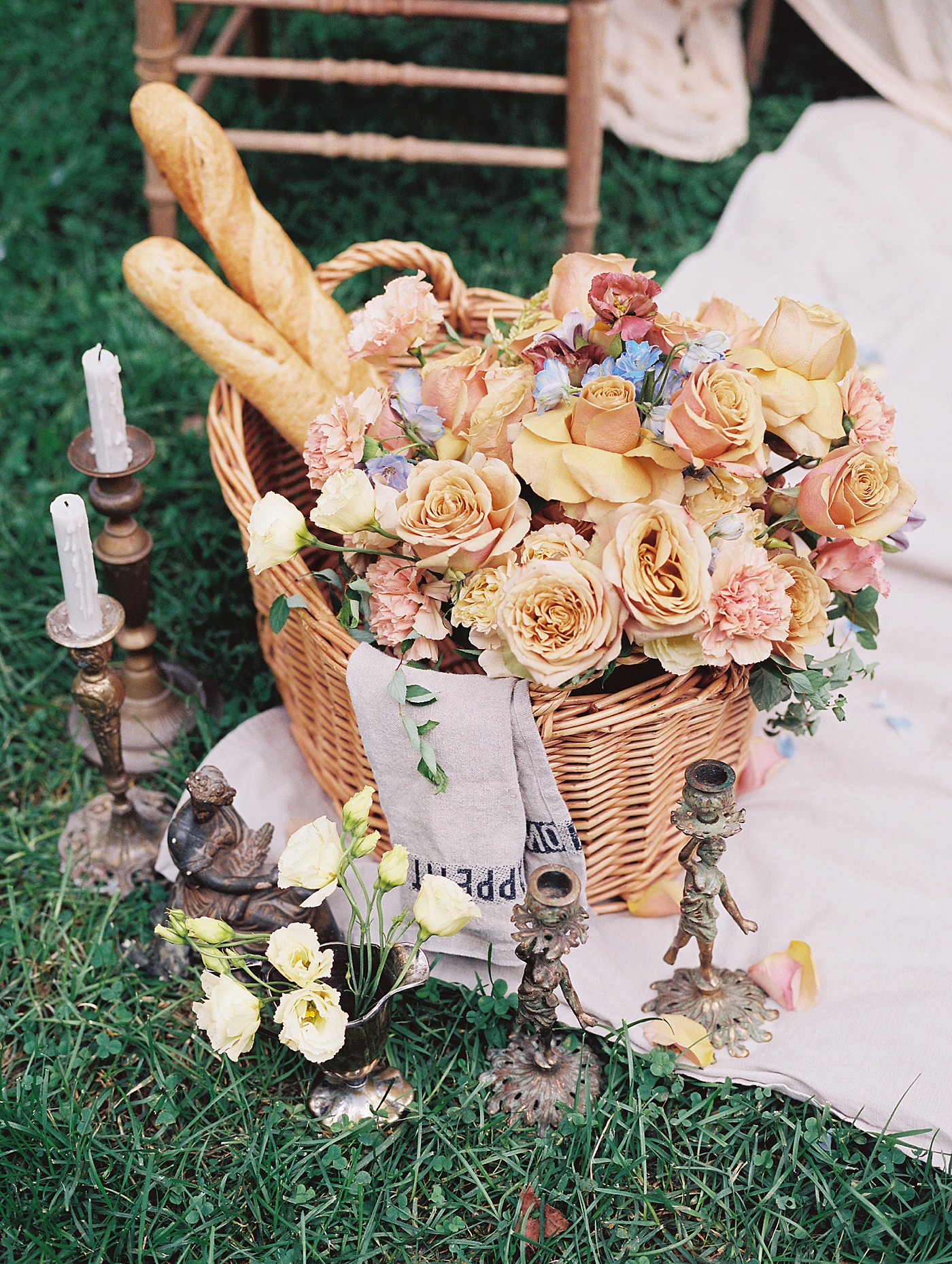 Vintage candlesticks styled with roses and baguettes | Image by Hope Helmuth Photography