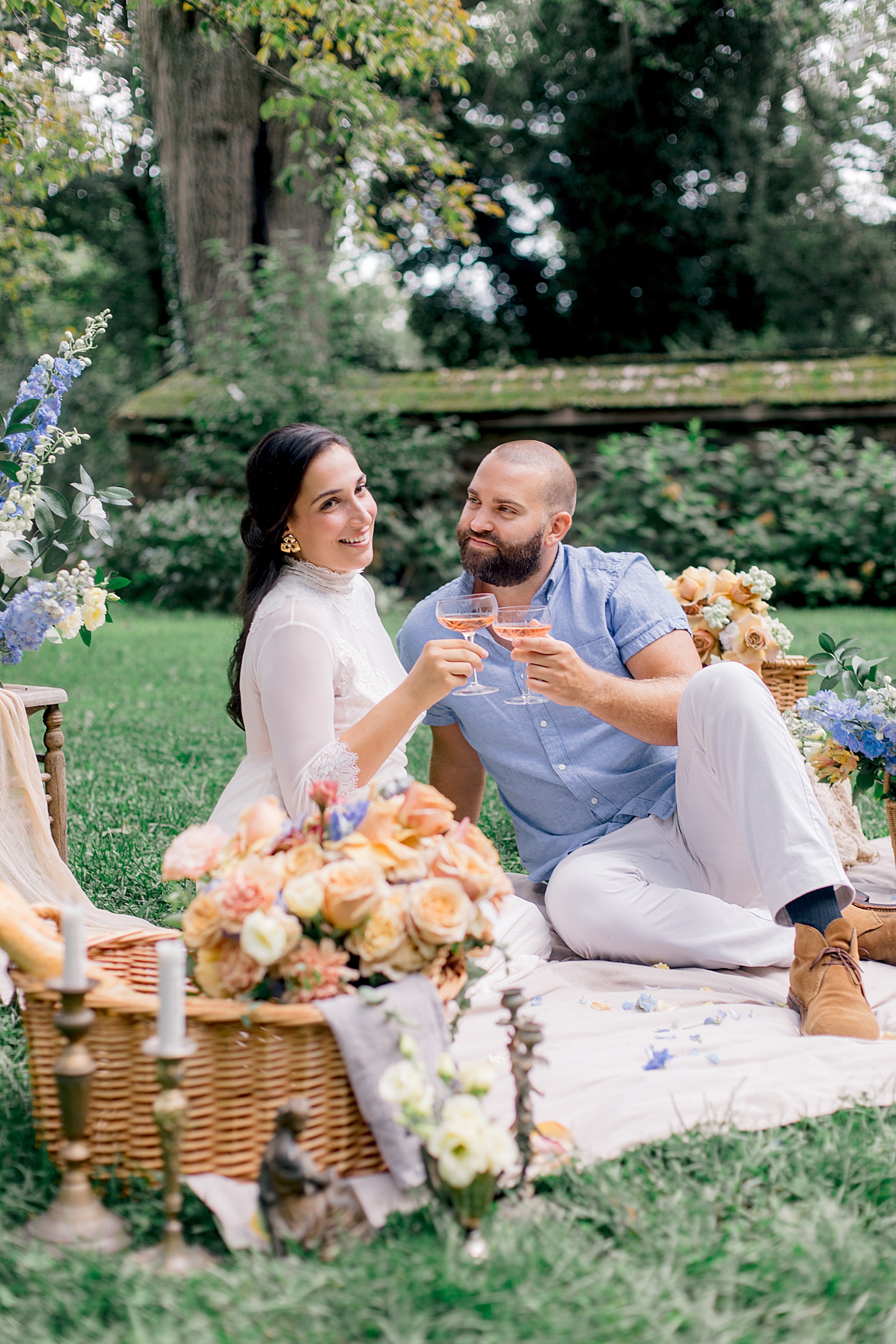 Bride and groom having a picnic toasting rose | Styling and Planning Engagement Sessions with Hope Helmuth Photography