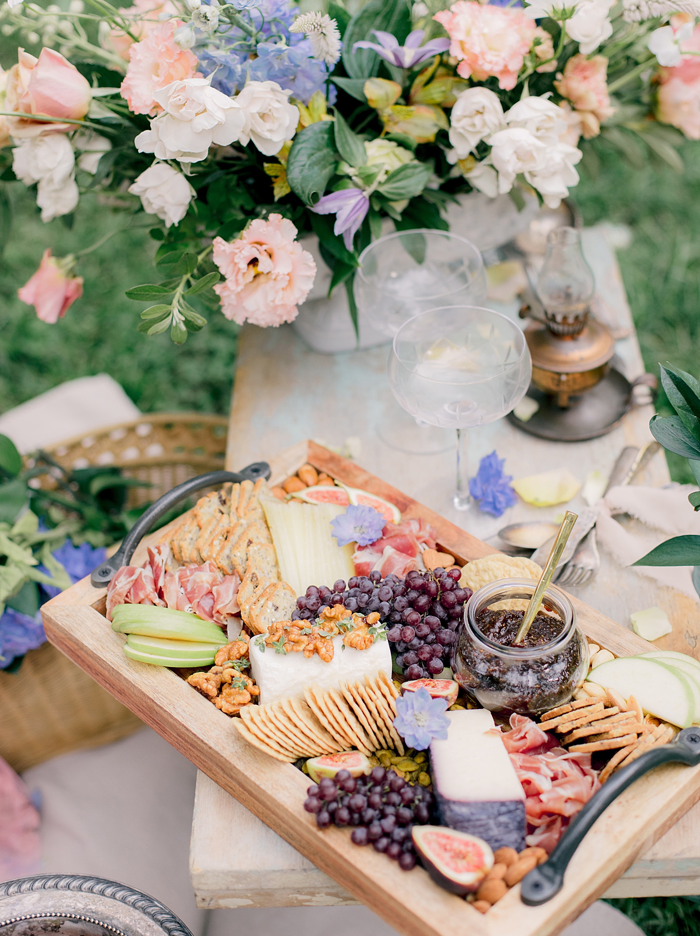 Charcuterie styled with florals and two champagne flutes | Image by Hope Helmuth Photography