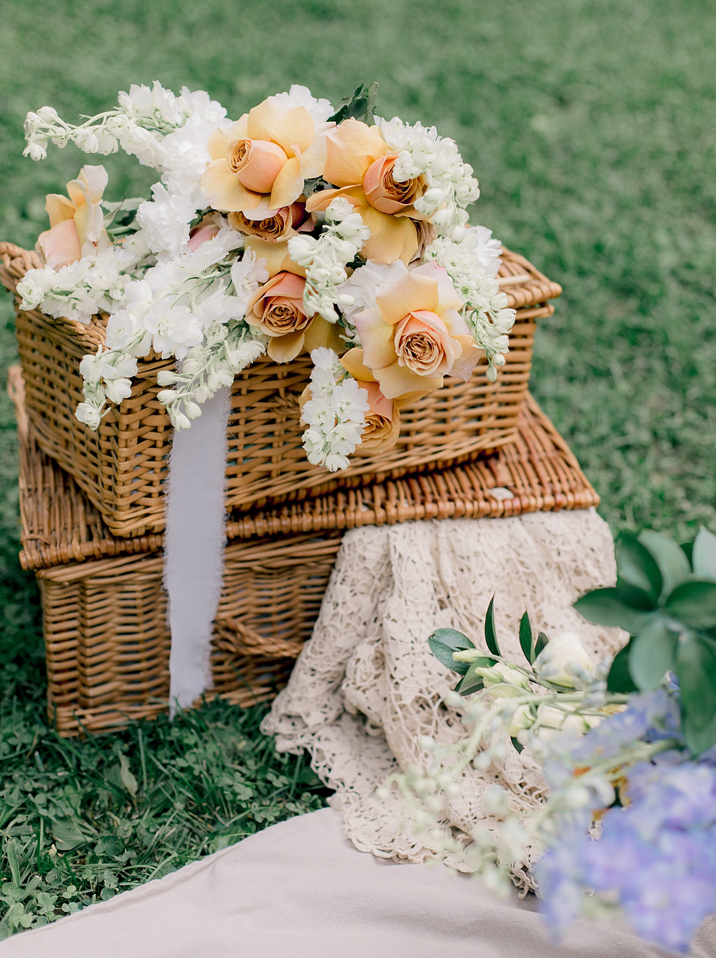Bouquet of peach roses and white stock flowers on picnic baskets | Styling and Planning Engagement Sessions with Hope Helmuth Photography