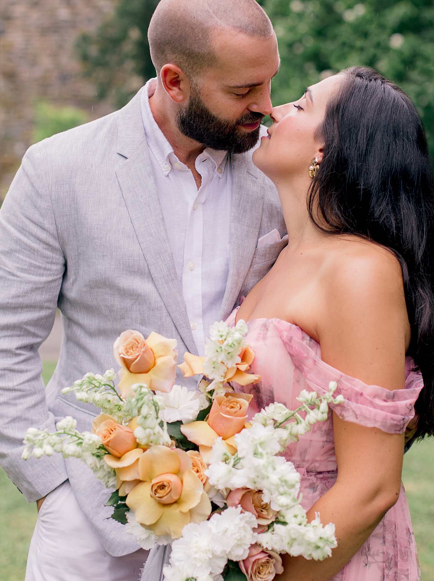 Bride and groom kissing holding a bouquet | Styling and Planning Engagement Sessions with Hope Helmuth Photography