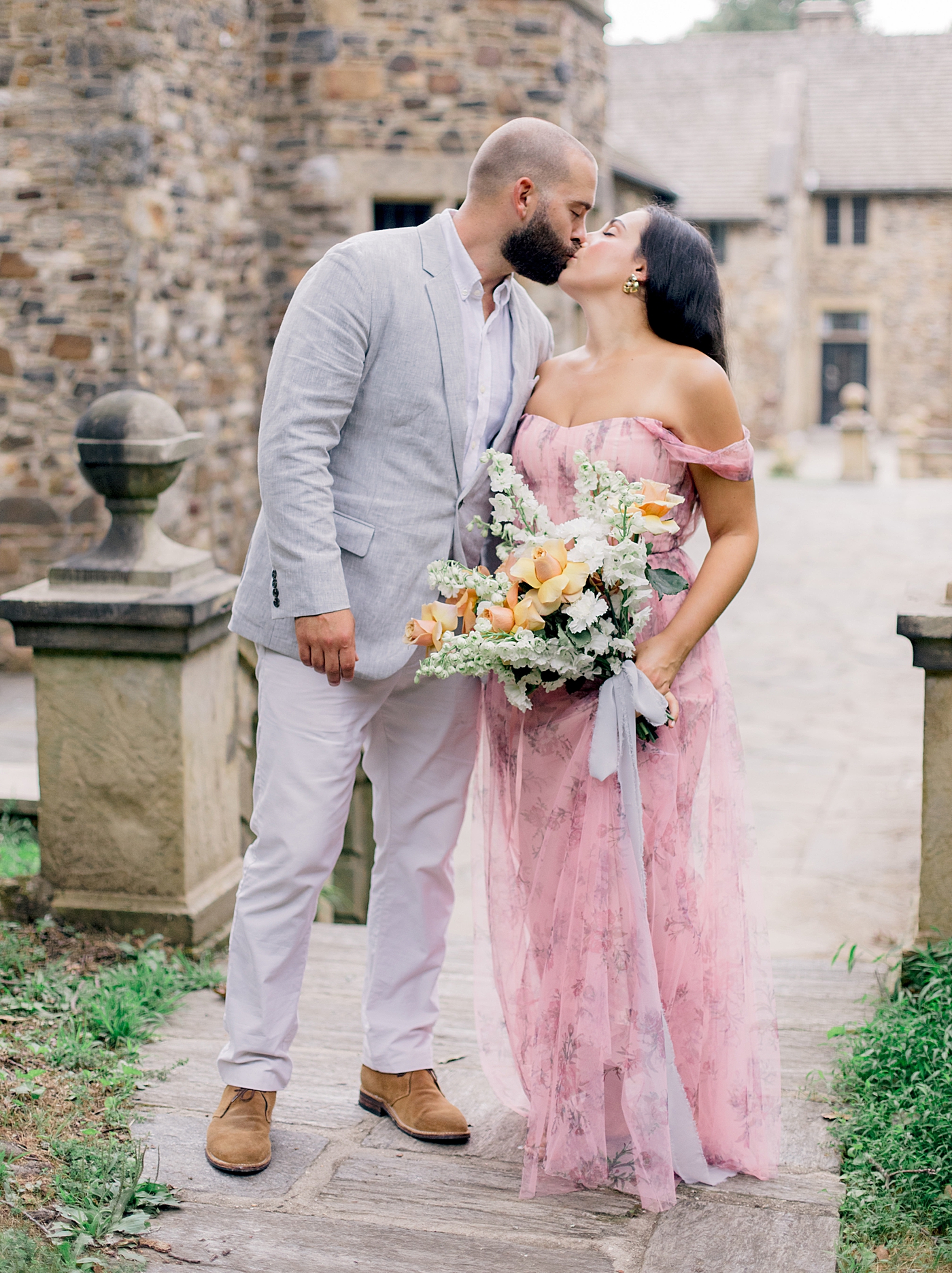 Couple in pink and gray kissing | Styling and Planning Engagement Sessions with Hope Helmuth Photography