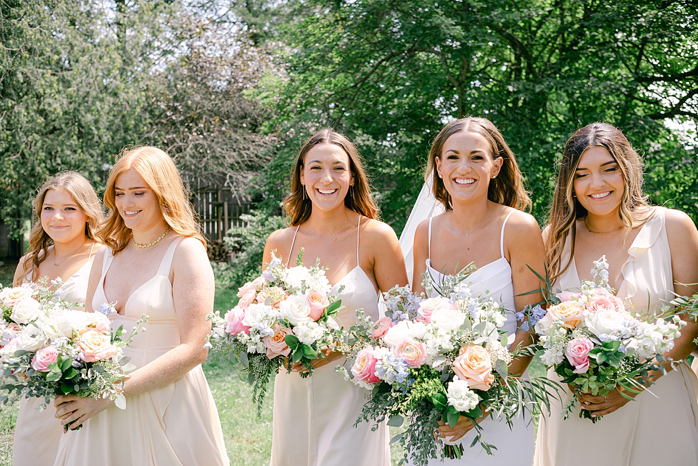 Bride walking with her bridesmaids | Image by Hope Helmuth Photography