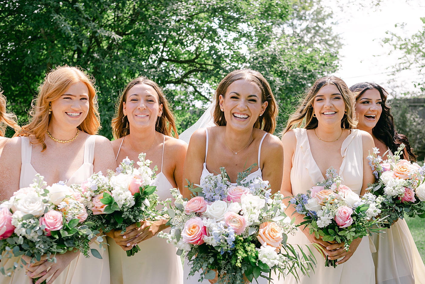 Bride laughing with her bridesmaids | Image by Hope Helmuth Photography
