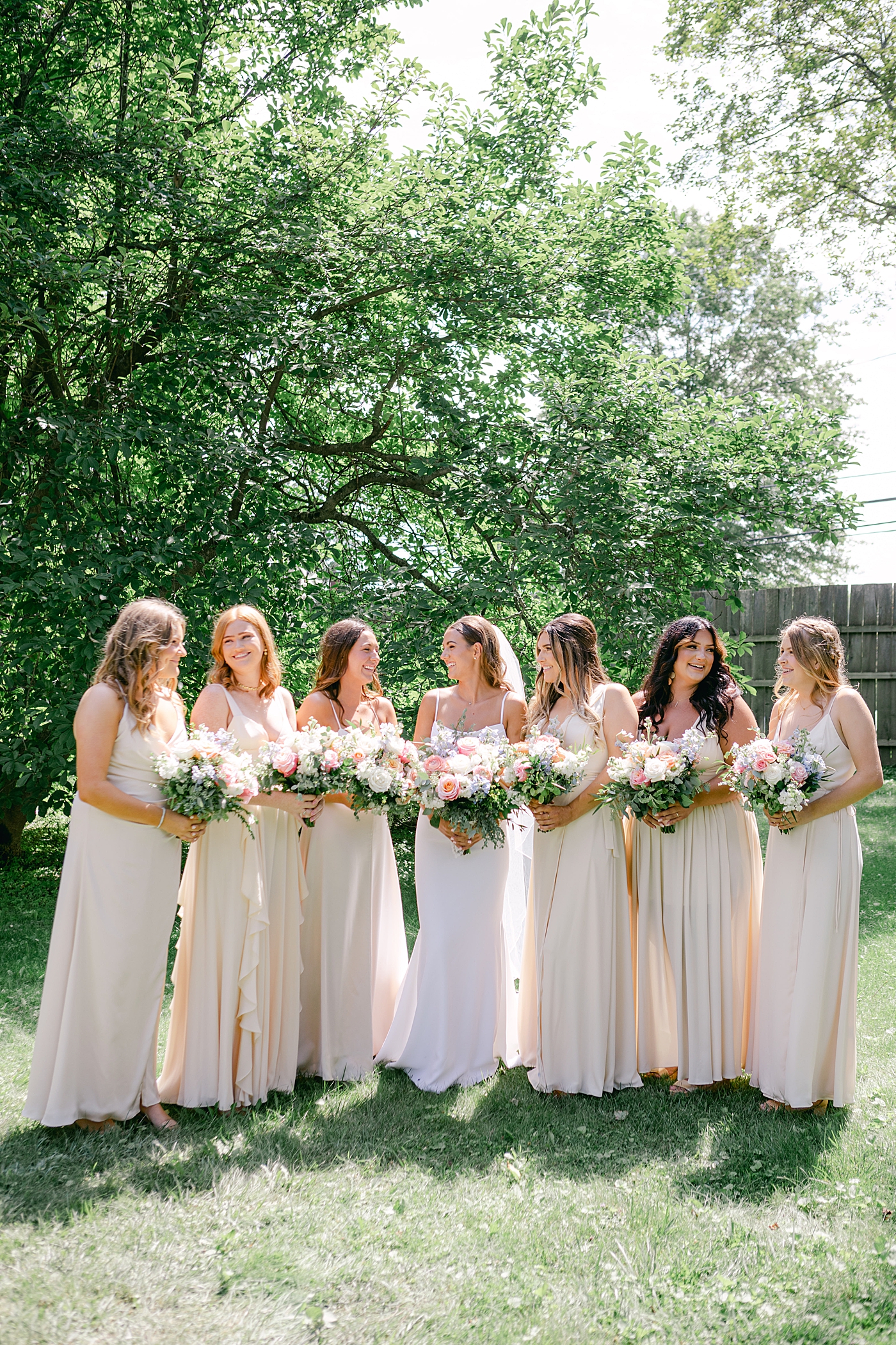 Bride standing with her bridesmaids | Image by Hudson Valley Wedding Photographer Hope Helmuth