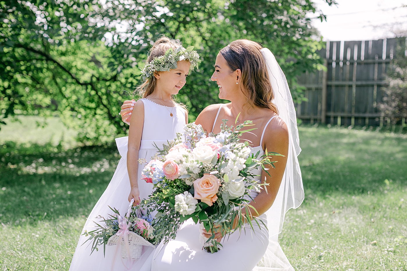 Bride with flower girl | Image by Hope Helmuth Photography
