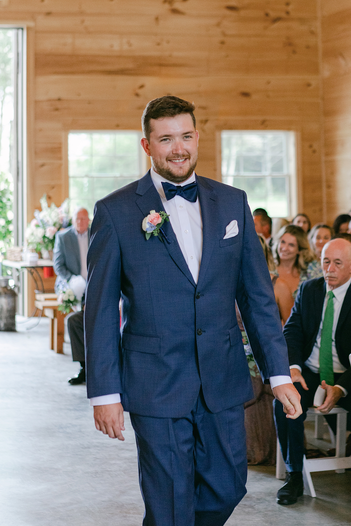 Groom smiling walking down the aisle | Image by Hudson Valley Wedding Photographer Hope Helmuth