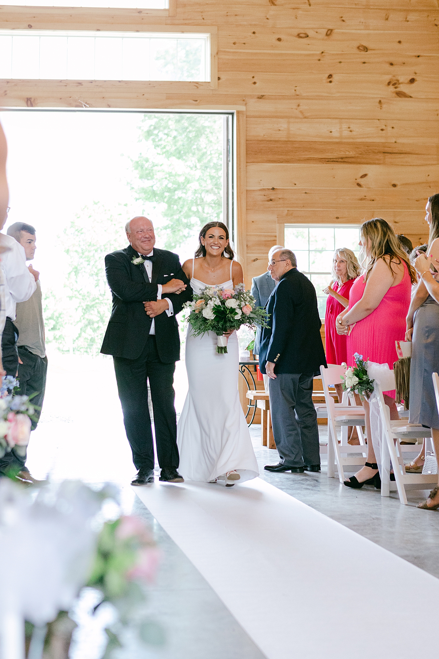 Bride walking down the aisle with her dad | Image by Hope Helmuth Photography