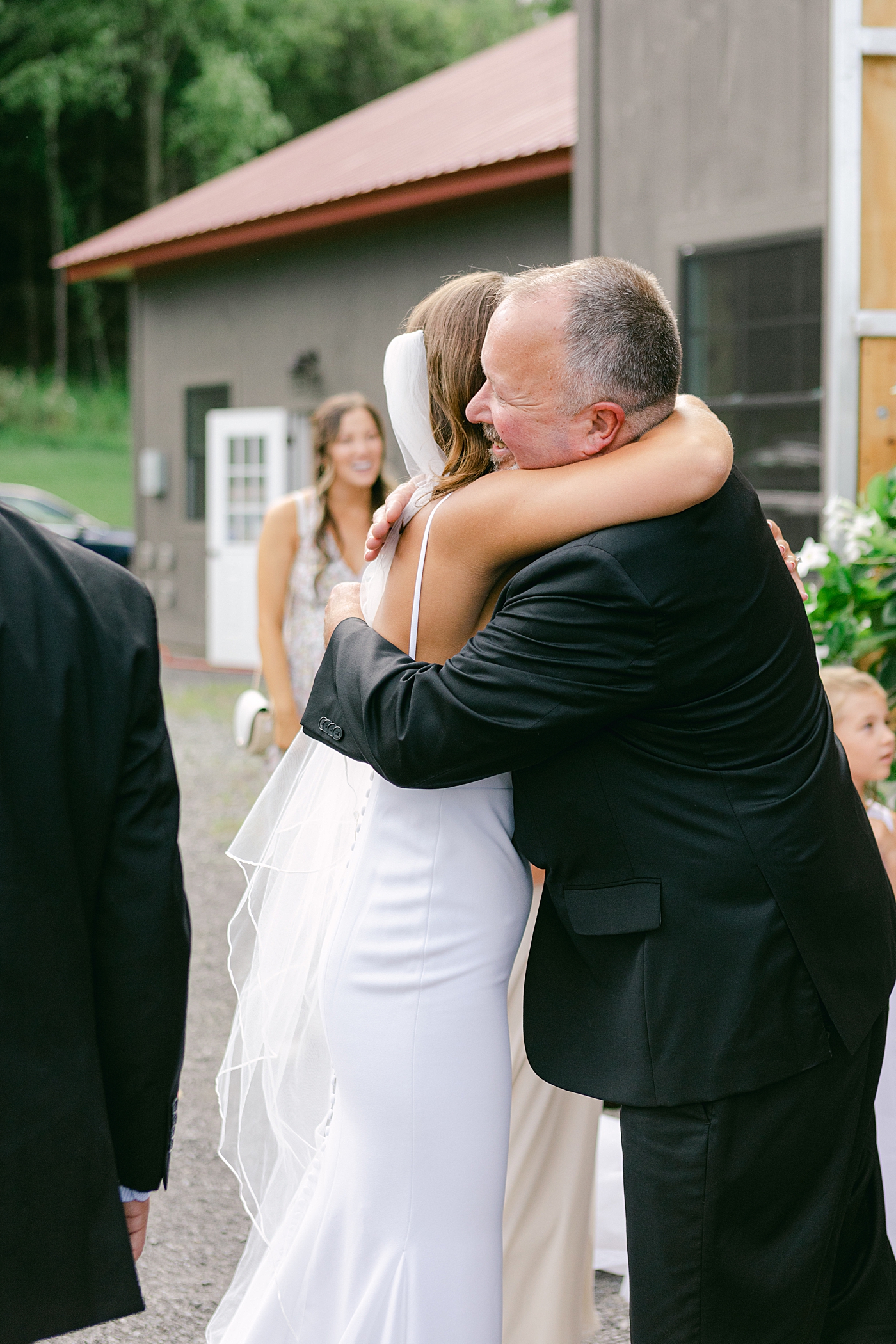Bride hugging her dad after wedding ceremony | Image by Hudson Valley Wedding Photographer Hope Helmuth