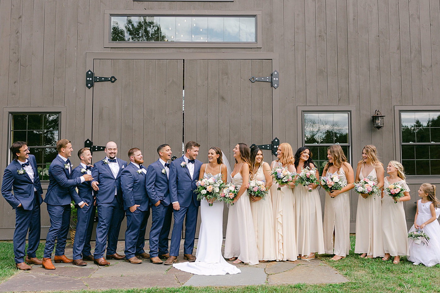 Wedding party laughing together | Image by Hope Helmuth Photography