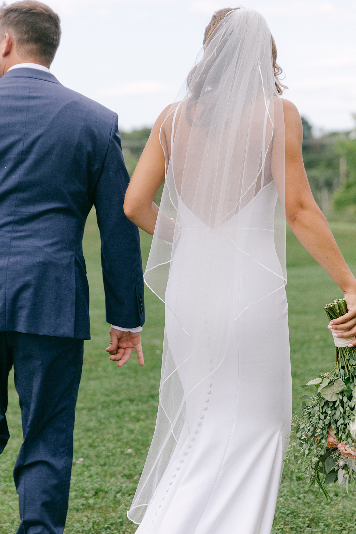 Bride and groom walking together after their ceremony | Image by Hope Helmuth Photography