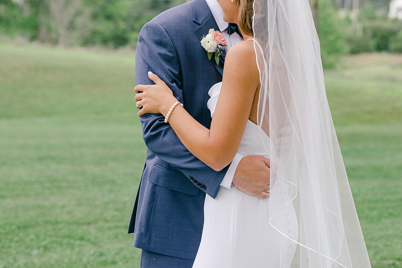 Detail of bride and groom embracing | Image by Hope Helmuth Photography