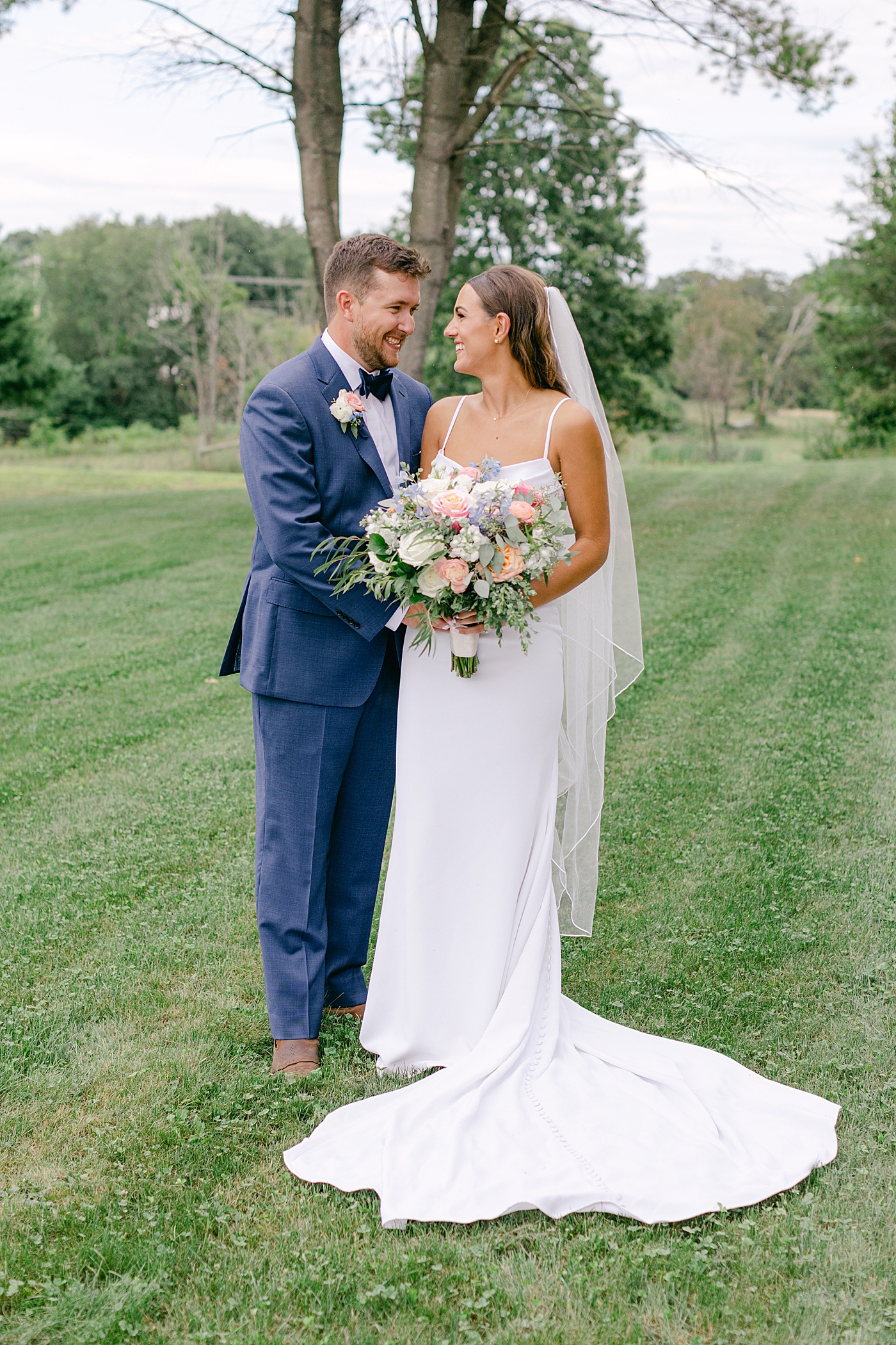 Bride and groom smiling during portraits | Image by Hope Helmuth Photography