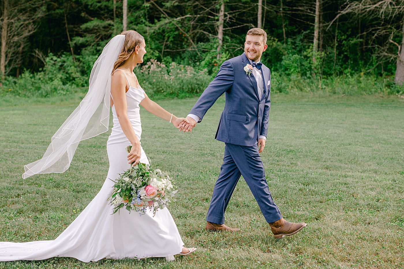 Bride and groom walking holding hands | Image by Hope Helmuth Photography