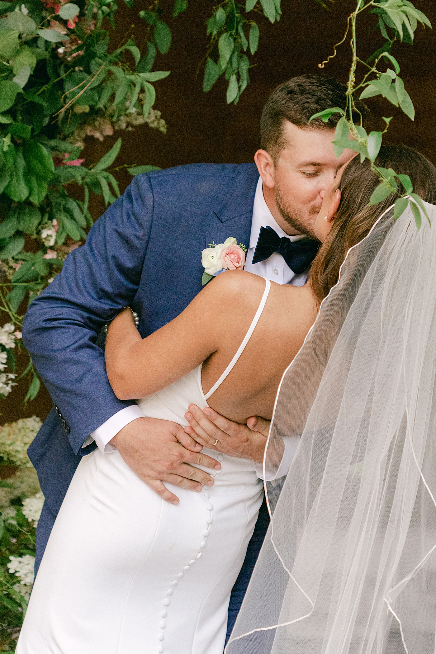 Bride and groom kissing during portraits | Image by Hope Helmuth Photography