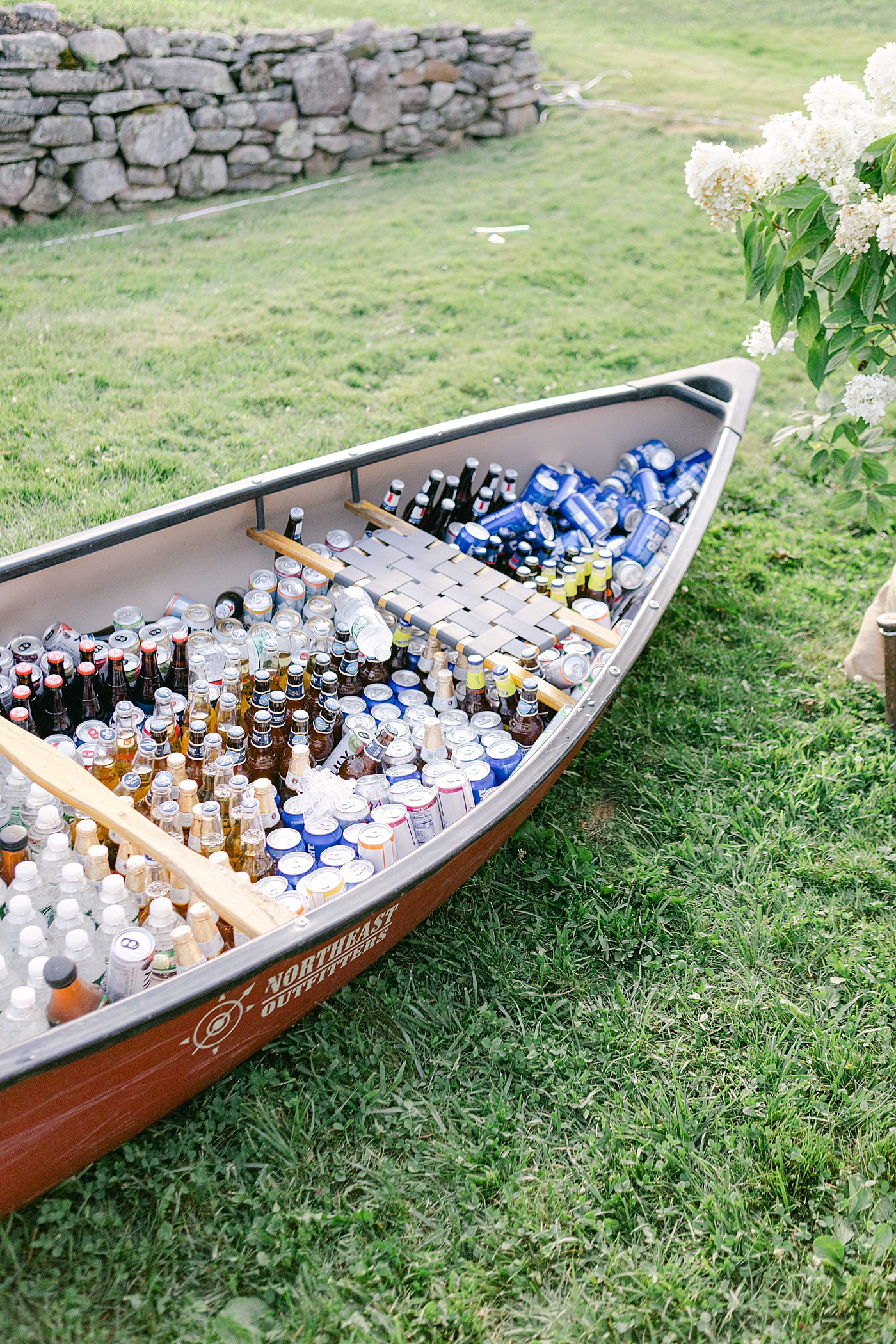 Canoe filled with beer during wedding reception | Image by Hope Helmuth Photography