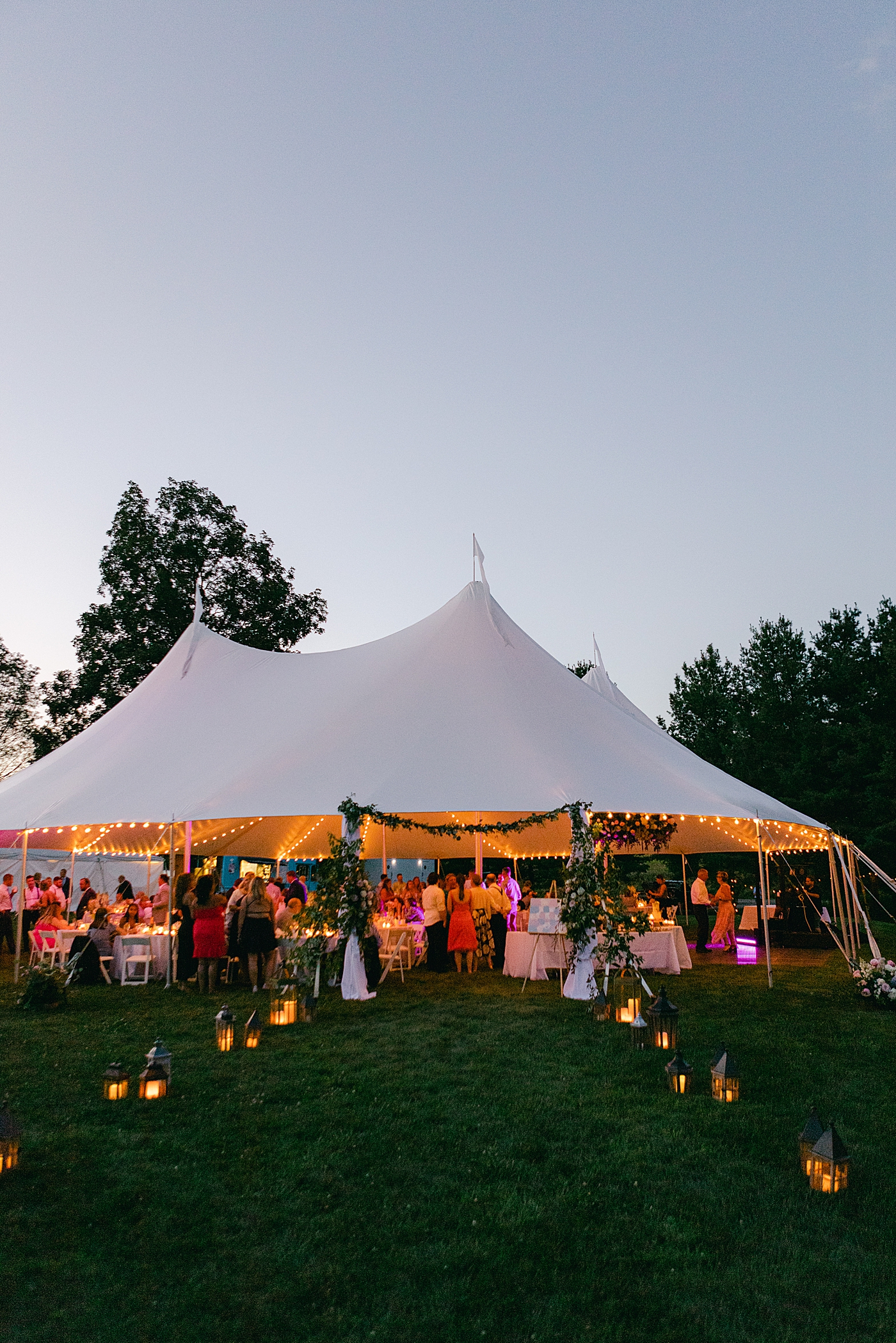 Tented wedding reception at dusk | Image by Hope Helmuth Photography