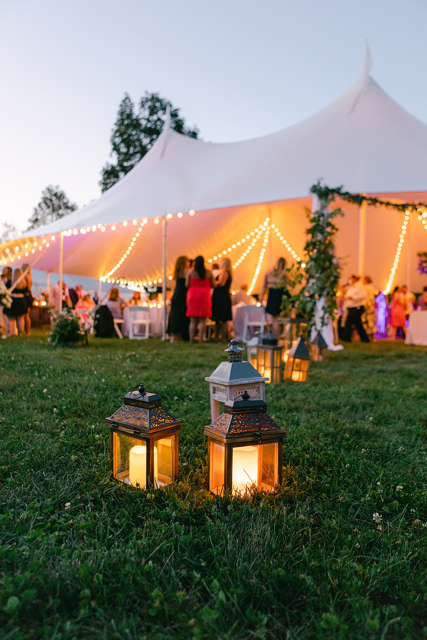 Lanterns during an outdoor wedding | Image by Hope Helmuth Photography
