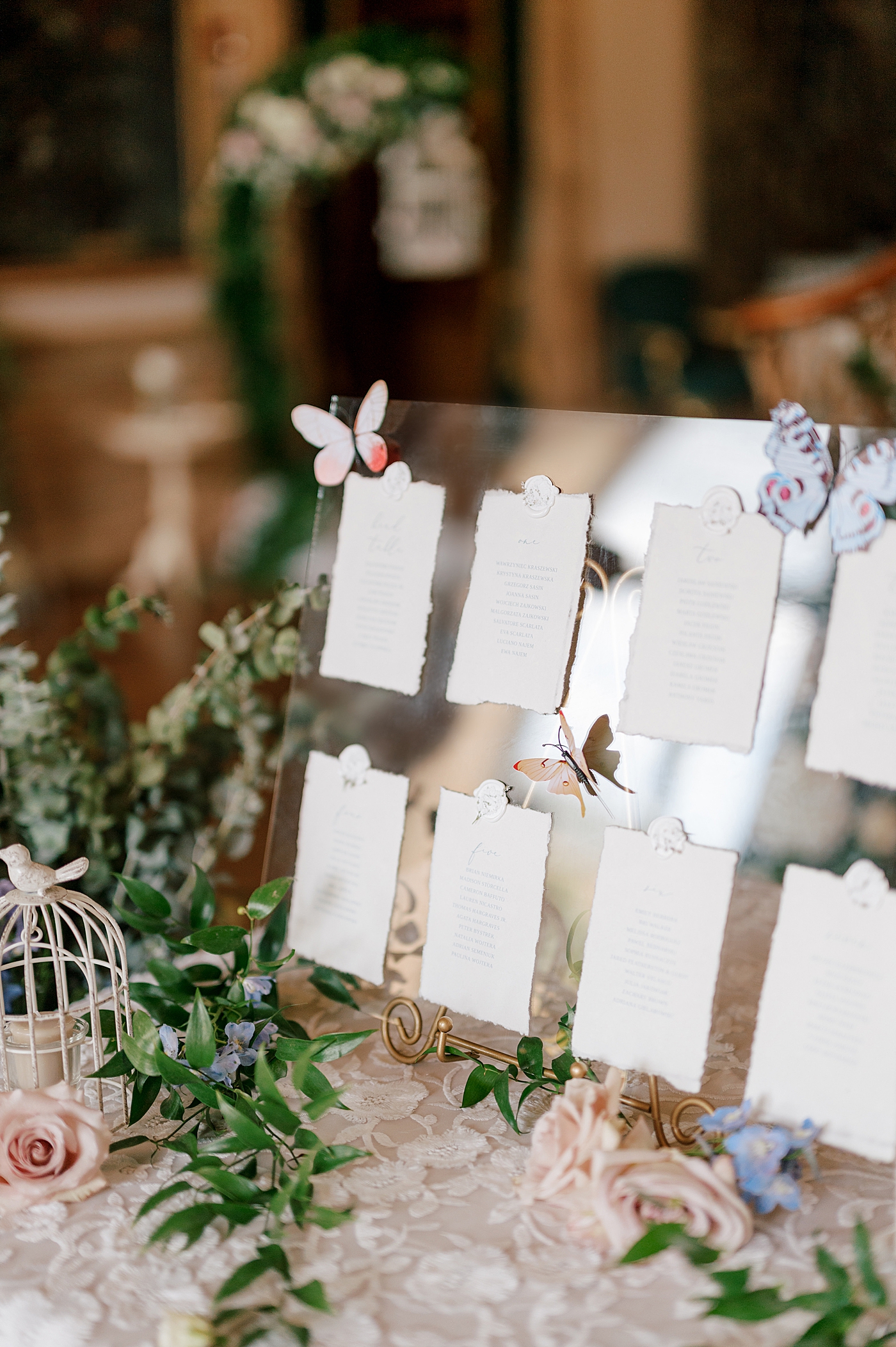 Guests seating chart with butterflies and flowers | Image by Hope Helmuth Photography
