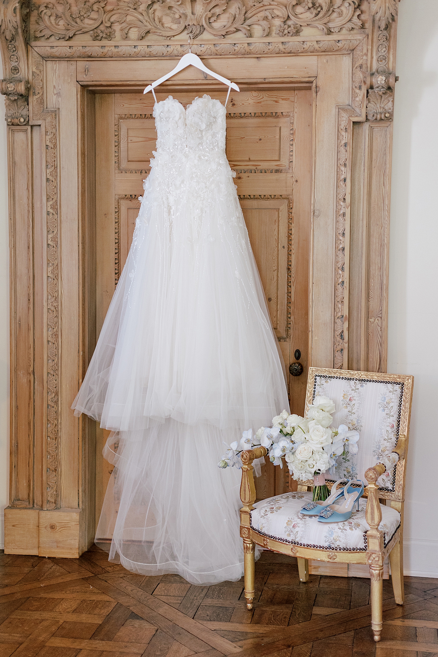 Wedding gown hanging from door | Image by Hope Helmuth Photography