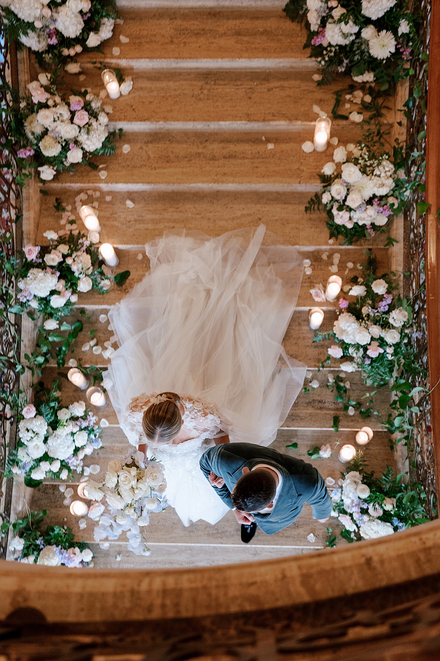Overhead image of bride and groom walking down the stairs | Image by Hope Helmuth Photography