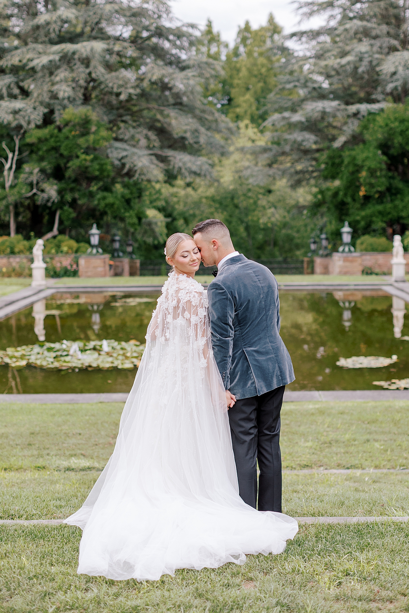 Bride and groom snuggling near a pond | Image by Hope Helmuth Photography