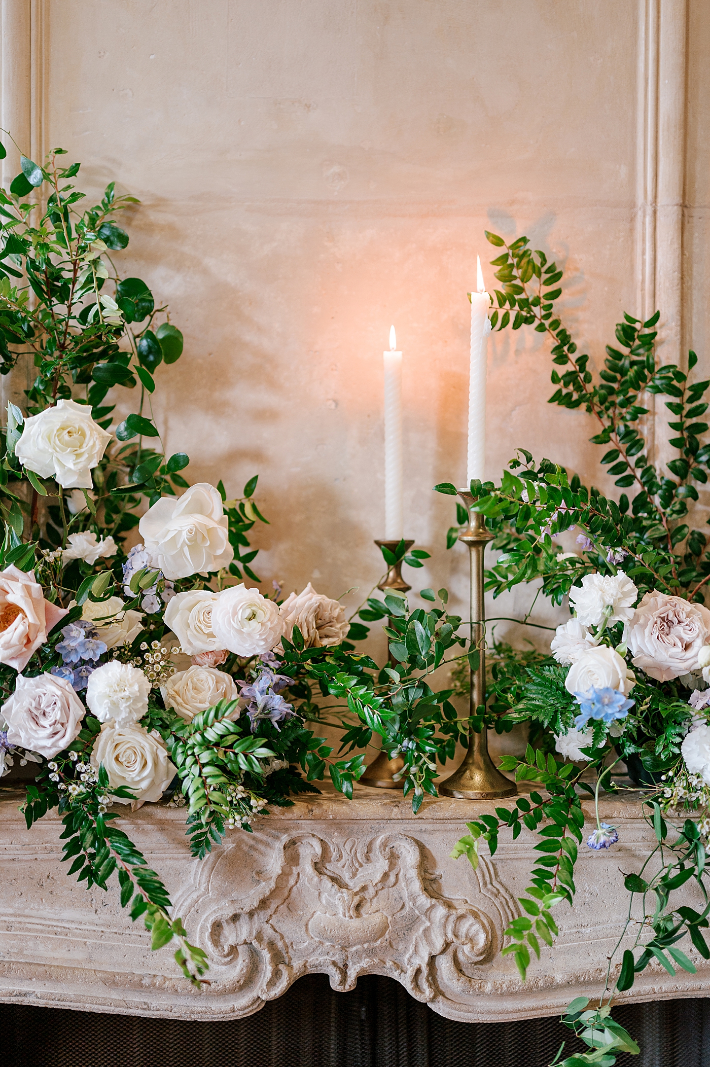 Mantle with fresh flowers and tapered candles | Image by Hope Helmuth Photography