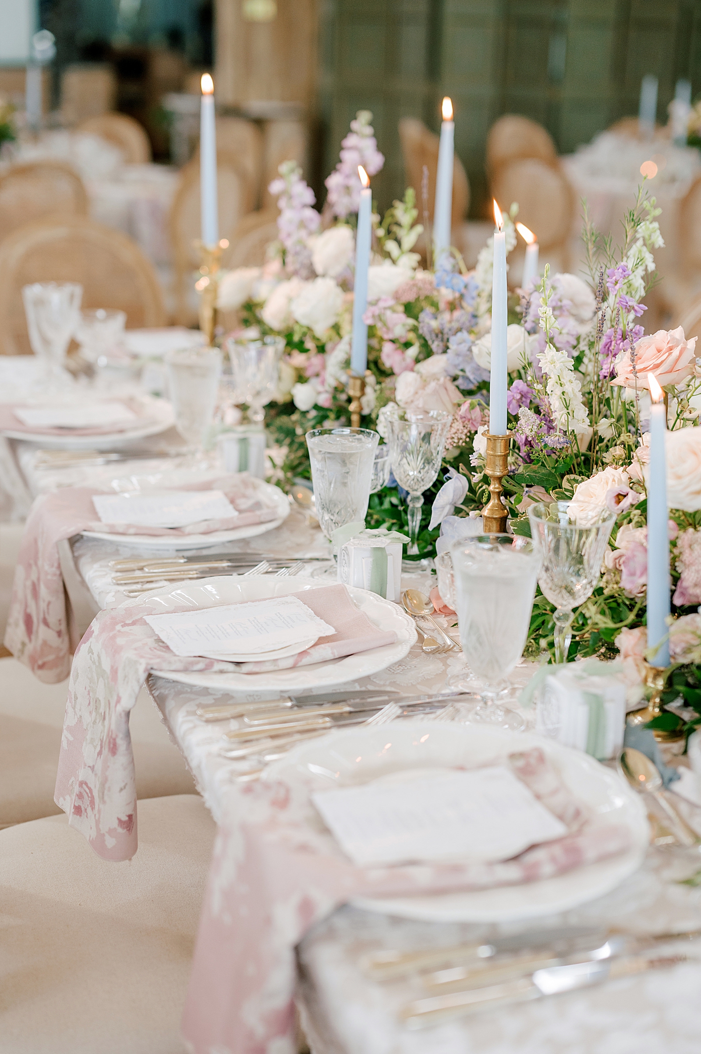 Reception table with tapered candles and wedding flowers | Image by Hope Helmuth Photography