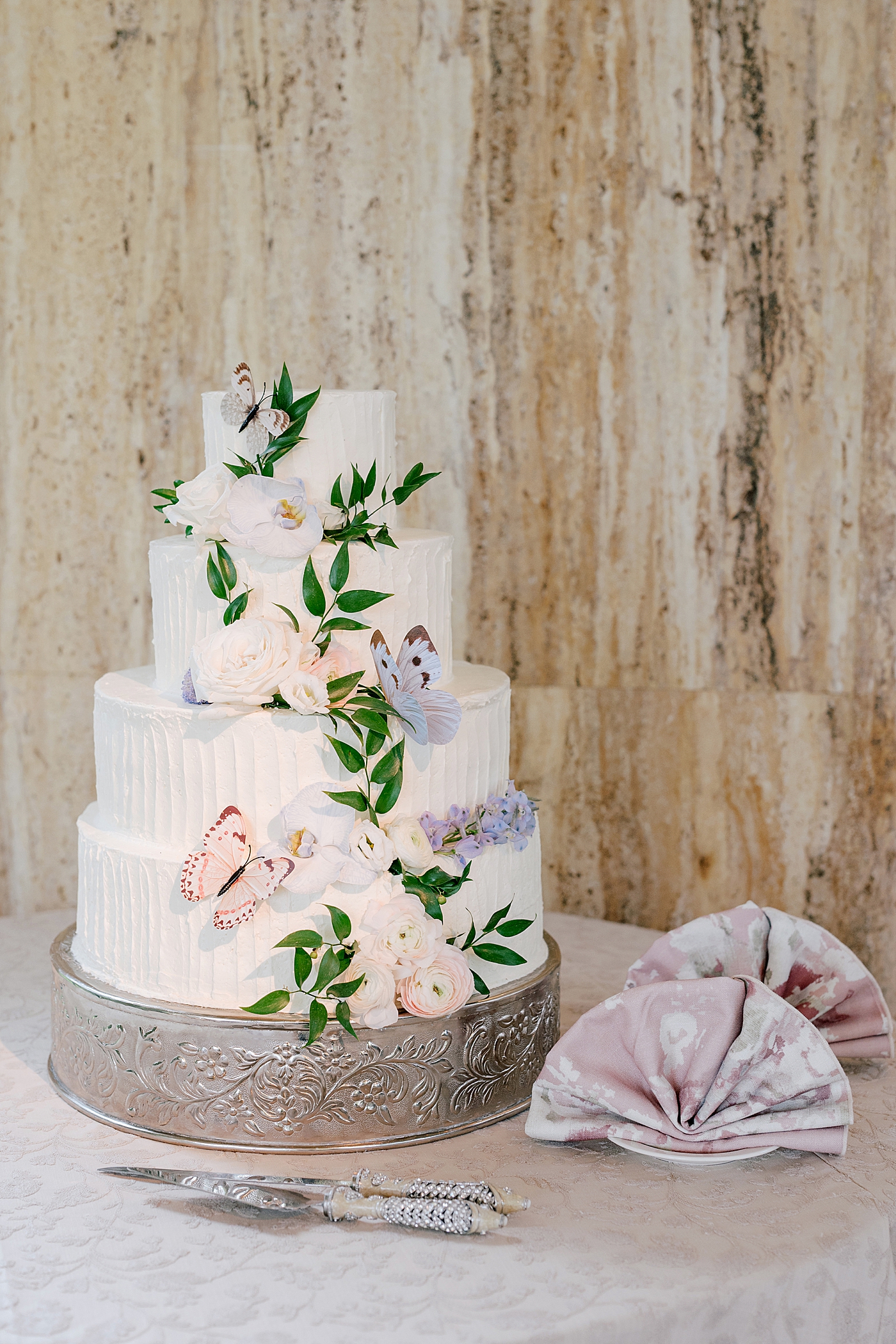 Wedding cake with flowers and butterflies | Image by Hope Helmuth Photography