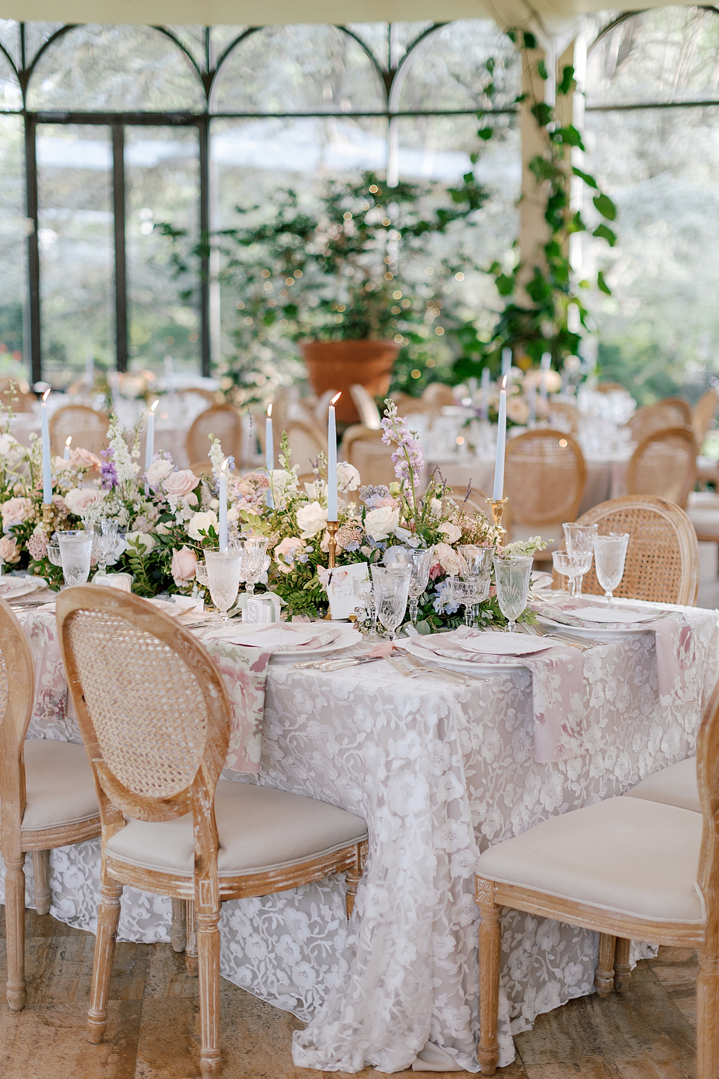 Reception table with flowers and tapered candles | Image by Hope Helmuth Photography
