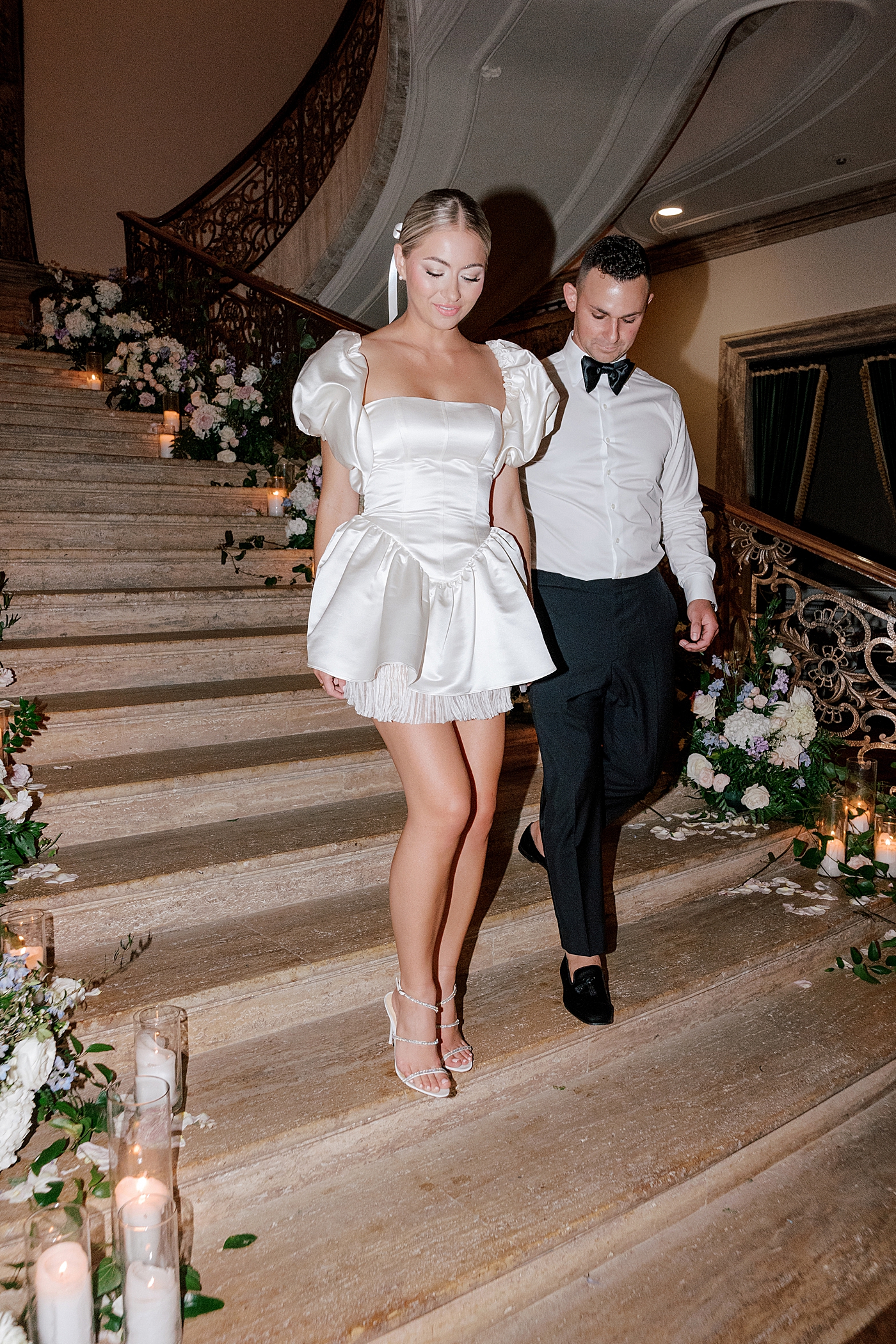 Bride and groom walking down stairs | Image by Hope Helmuth Photography