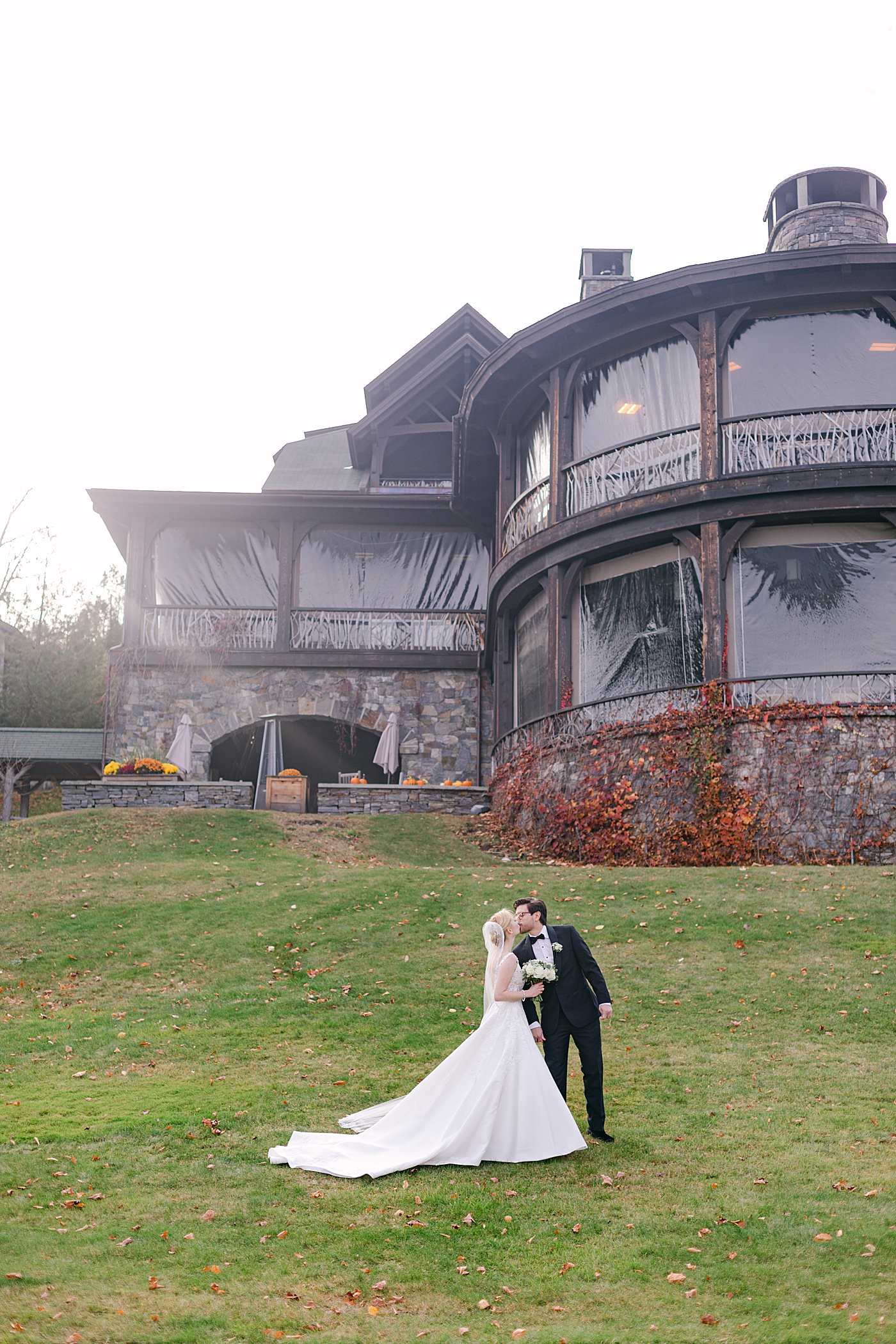 Bride and groom kiss during Lake Placid Lodge Wedding | Image by Hope Helmuth Photography