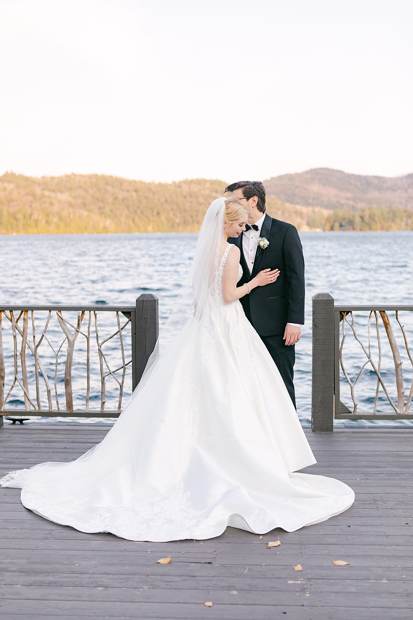 Bride and groom embracing on a dock | Image by Hope Helmuth Photography