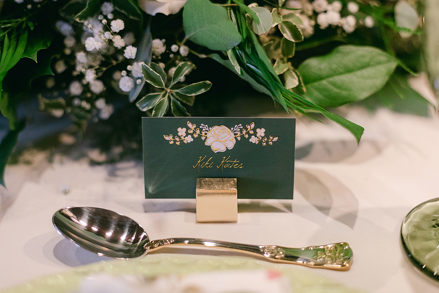 Green table settings with gold details | Image by Hope Helmuth Photography