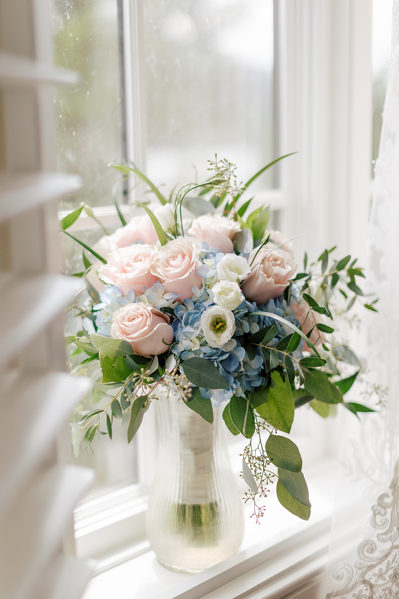 Bridal bouquet in a window | Image by Hope Helmuth Photography