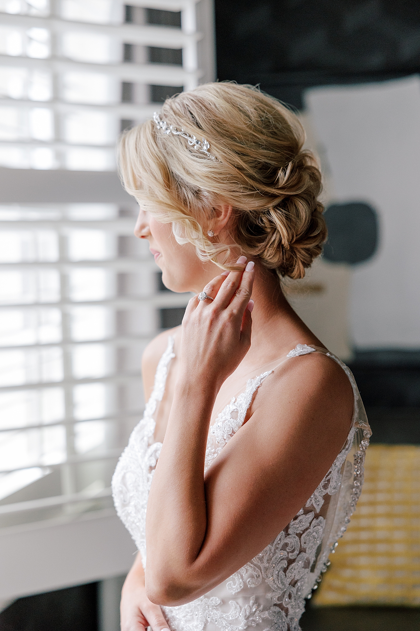 Bride adjusting her hair before River House Odette's Wedding | Image by Hope Helmuth Photography