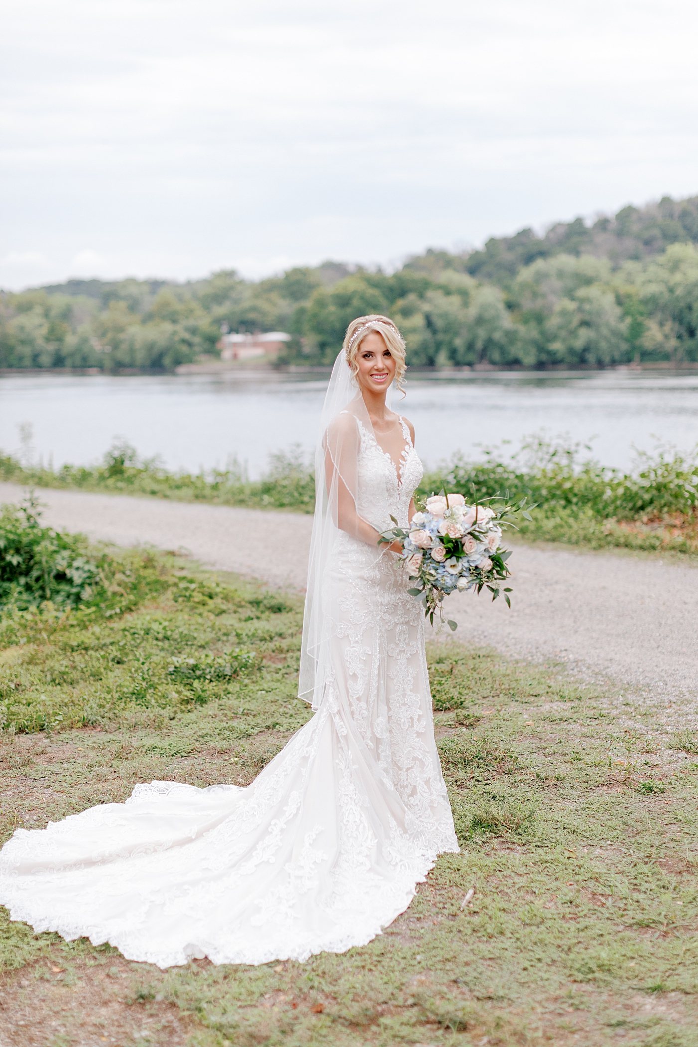 Bride smiling and holding her bouquet | Image by Hope Helmuth Photography