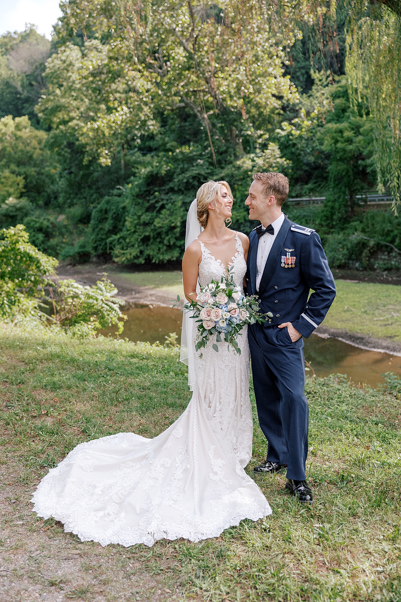 Bride and groom embracing near the water | Image by Hope Helmuth Photography