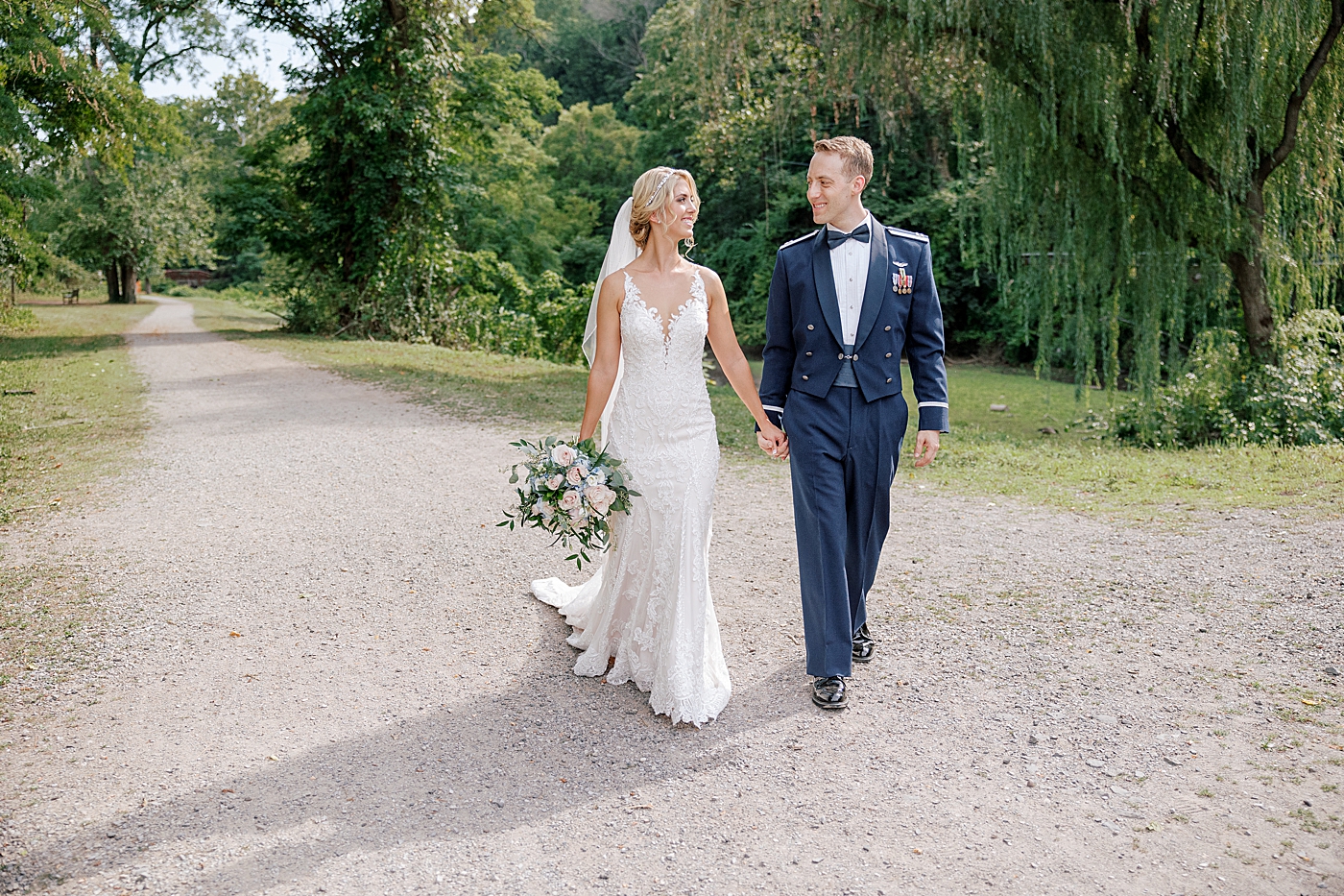 Bride and groom walking on a path after River House Odette's Wedding | Image by Hope Helmuth Photography