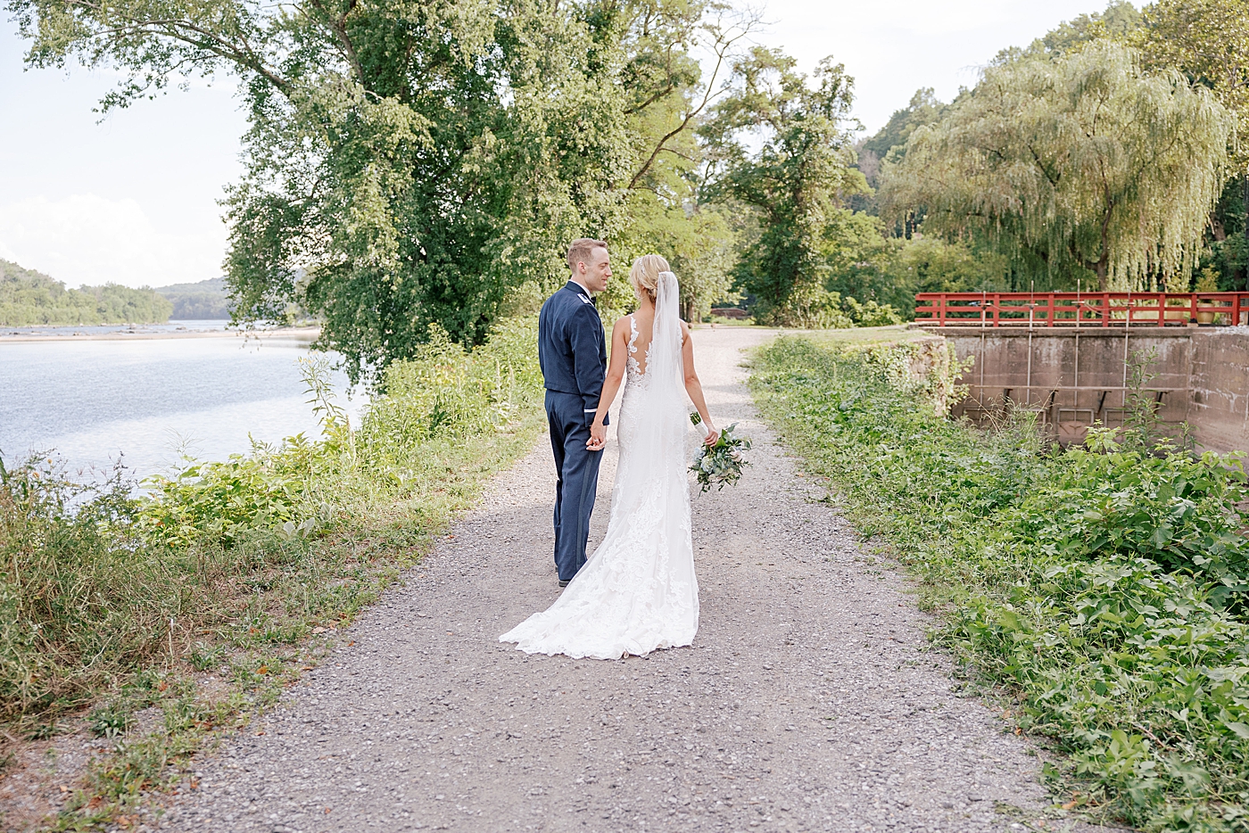 Bride and groom walking on a path | Image by Hope Helmuth Photography