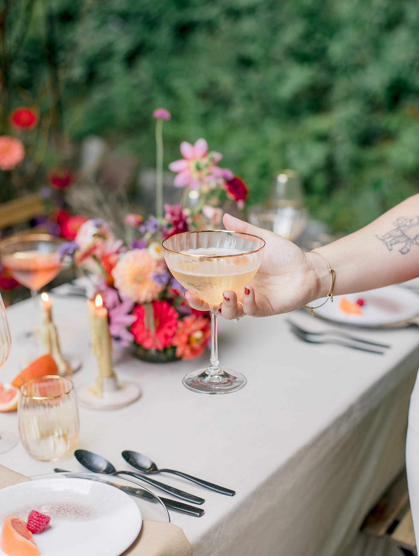 Bride holding champagne flute during Adirondack Mountain Elopement Weekend | Image by Hope Helmuth Photography
