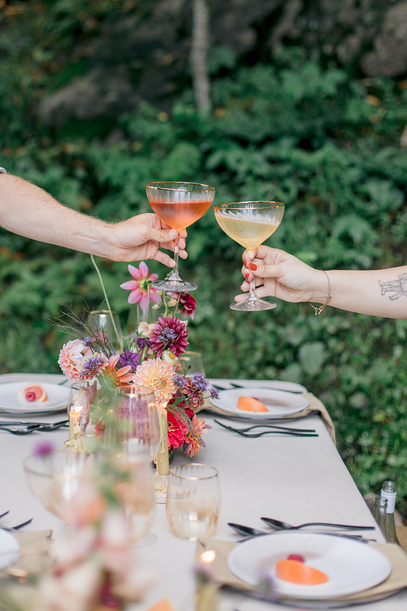 Couple cheers champagne flutes during Adirondack Mountain Elopement Weekend | Image by Hope Helmuth Photography