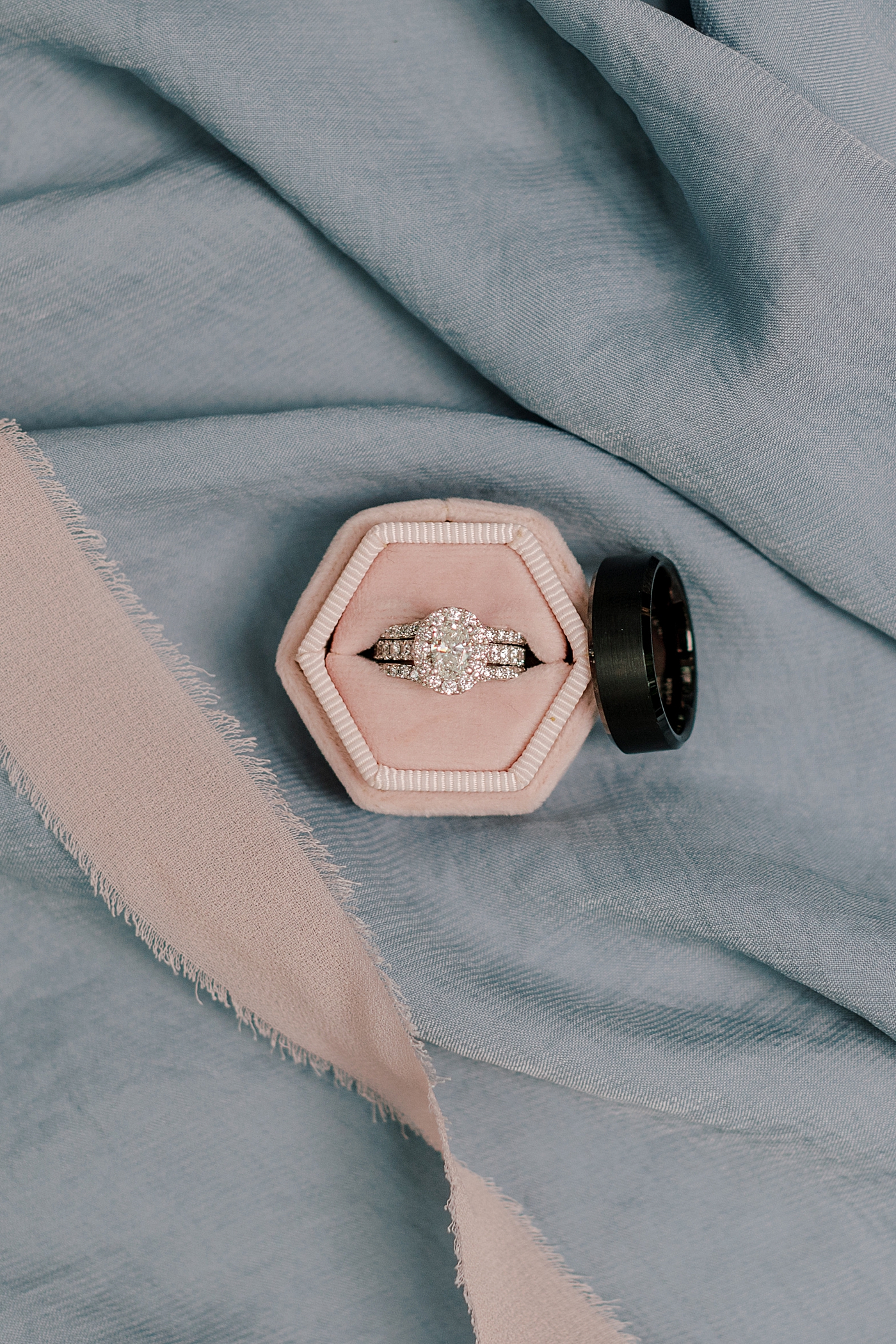 Wedding ring in a pink box with pink ribbon | Image by Hope Helmuth Photography 