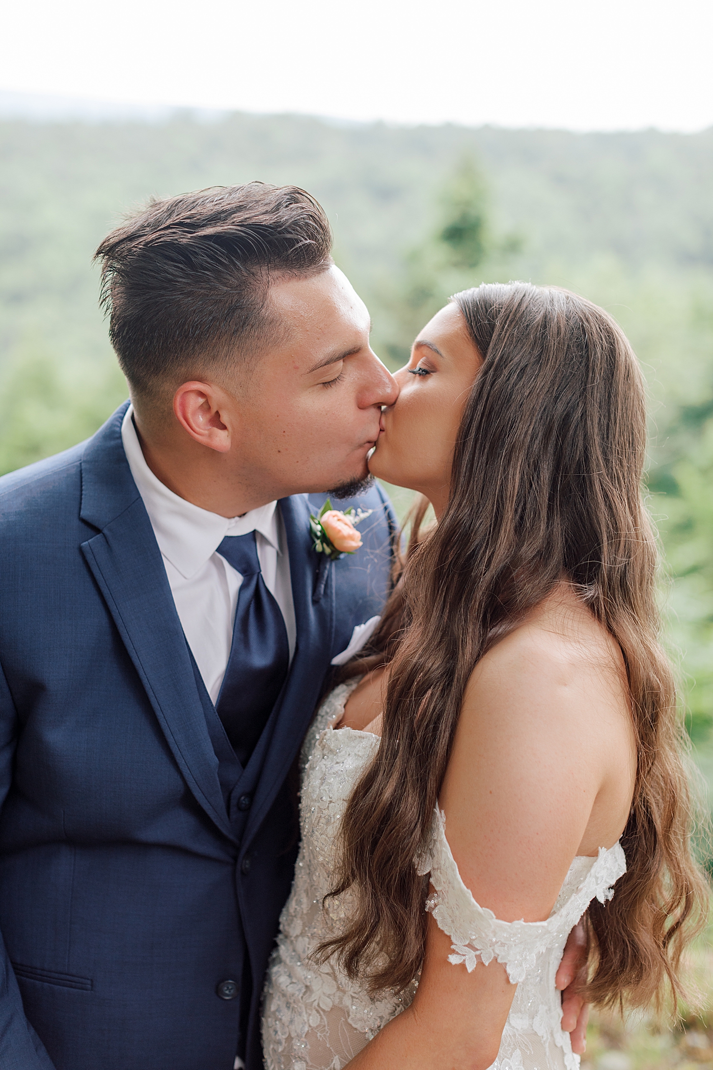 Bride and groom kiss with mountains in the background | Image by Hope Helmuth Photography 